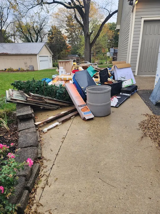 Dumpster being loaded with debris for Estate Cleanout Dumpster Rental in Saginaw